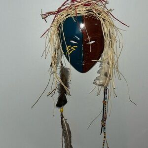 African mask with beads and feathers